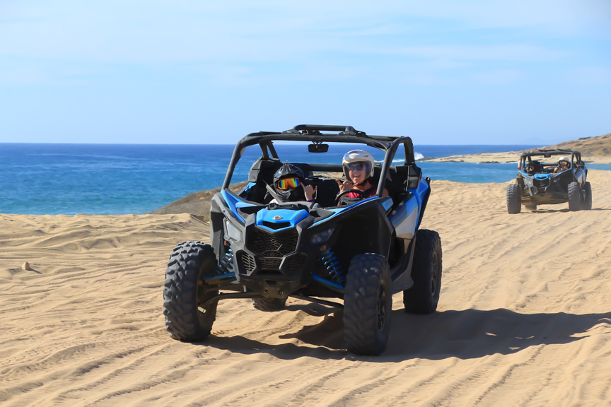 Riding a dune buggie in the sand by the ocean